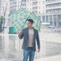 Young handsome man posing with umbrella