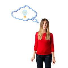 Cute young girl thinking an idea over isolated white background