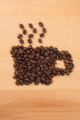 Roasted coffee beans in coffee cup shape