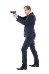 secret agent man in business suit posing with gun isolated on wh