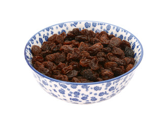 Raisins in a blue and white china bowl