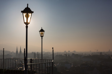 old lamp posts above city