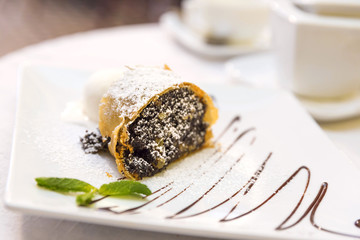 Poppy seeds and walnuts strudel with vanilla ice cream and mint