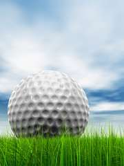 White golf ball in grass and sky