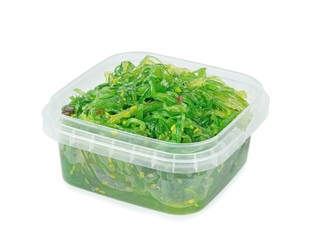 A plastic tub of fresh wakame seaweed on a white background