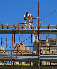 Fototapeta premium Constructrion site - scaffold and worker