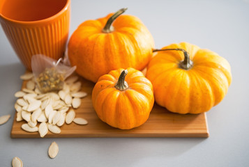 Closeup on small pumpkins and seeds on table