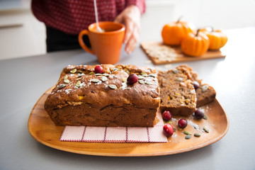 Closeup on freshly baked pumpkin bread with seeds and young hous