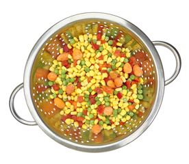 Colander with frozen mixed vegetables isolated on white
