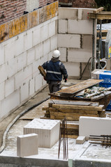 Fototapeta premium Bauarbeiter trägt Holzlatte