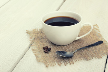Obraz na płótnie Canvas cup of coffee on a wooden background
