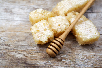 Honey with comb on wooden table