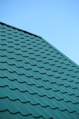 Fototapeta na wymiar Modern metal tile roofing against a blue sky
