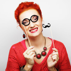 young woman holding mustache and glasses