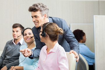 Manager Discussing With Customer Service Representatives In Offi