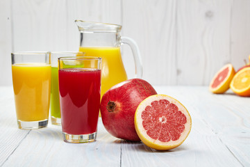 Glasses with fresh vegetable juices isolated on white table. Det