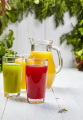 Glasses with fresh vegetable juices isolated on white table. Det