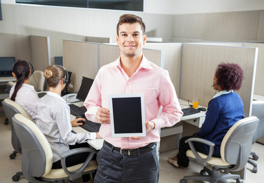 Businessman Holding Tablet Computer In Call Center