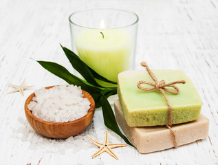 spa setting with candle, handmade soap and salt