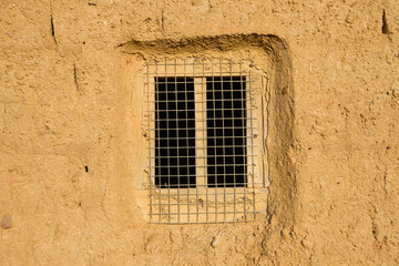 Fototapeta na wymiar Window in Adobe Wall