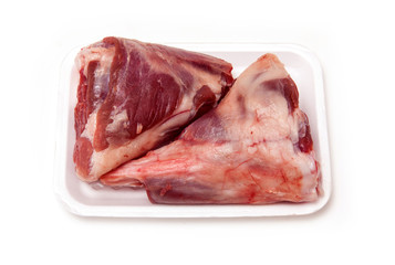Goat meat shanks isolated on a white studio background.