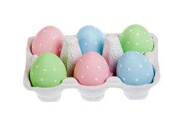 Fototapeta na wymiar pastel colored easter eggs in cardboard, isolated
