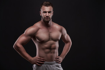Fototapeta na wymiar muscular man isolated on black background
