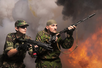 Portrait of soldiers with an automatic assault rifles
