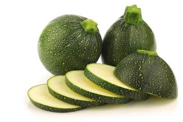 fresh Round Zucchini's and a cut one on a white background