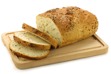 freshly baked cut loaf of cornbread on a  white background