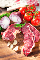 Fresh raw pieces of meet with vegetables ready to cook.