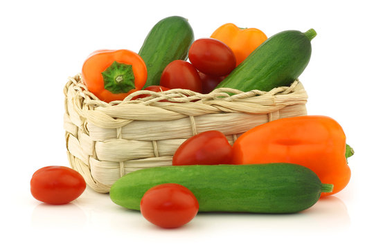 fresh vegetable snacks in a woven basket on a white background