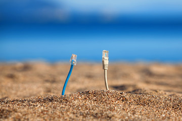 Fototapeta na wymiar Internet cables on a beach