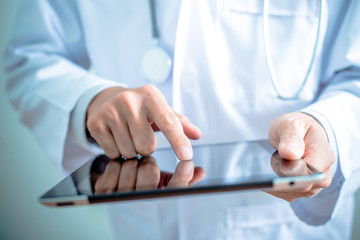 Doctor working on a digital tablet