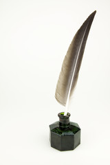 Quill pen and vintage glass inkwell isolated