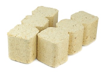 Compressed sawdust briquettes heating fuel on a white background