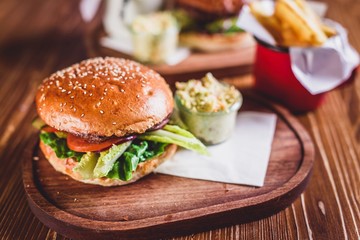 Fresh burger on wooden table.