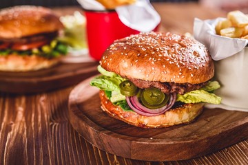 Fresh burger on wooden table.