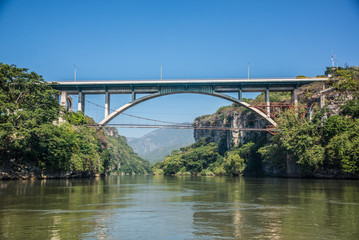Fototapeta na wymiar Bridge at Cañon del Sumidero. Wild river at Chiapas. Tour and a