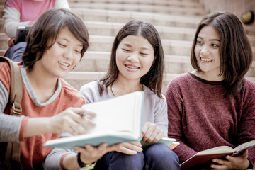 attractive female college student sitting on stairs