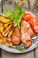 Roasted pork chop with baked potatoes