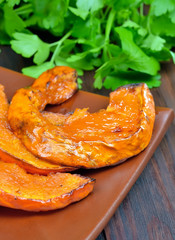 Baked pumpkin slices on plate
