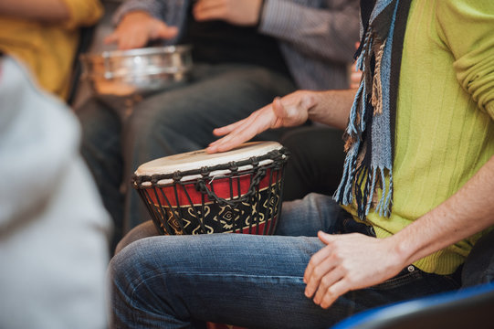 person playing on Jambe Drum no face