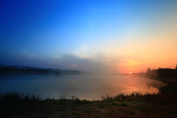 Fototapeta na wymiar sunrise on the lake fog landscape nature