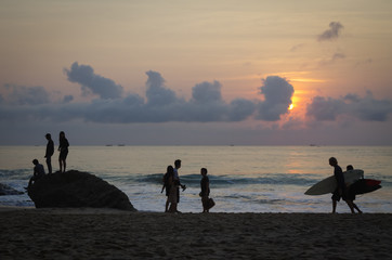group of people on dreamland beach at sunset - bali