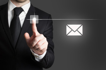 businessman pushing touchscreen button mail symbol