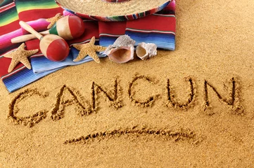 Fotobehang Mexico Cancun beach writing word written in sand on a mexico beach with sombrero and traditional blanket photo