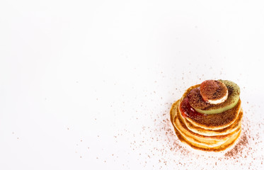 isolated stack of several pancake with cocoa and fruits