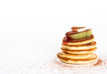 isolated stack of several pancake with cocoa and fruits