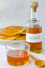 Agave syrup and a plate of pancakes.